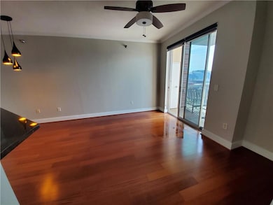 Spare room featuring ornamental molding, hardwood / wood-style flooring, and ceiling fan