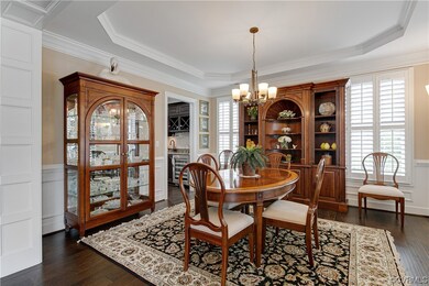 Dining area featuring a notable chandelier, dark h