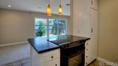 Kitchen opens to casual dining and living area.