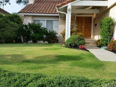 Entryway with manicured landscape