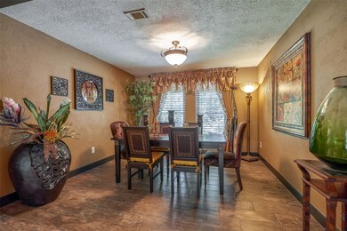 Formal dining area with recent woodgrain ceramic tile flooring.