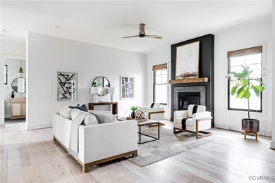 Living room featuring a fireplace, light hardwood