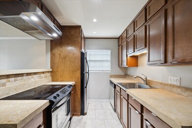 Kitchen has updated custom concrete countertops, stainless appliances and tile flooring.
