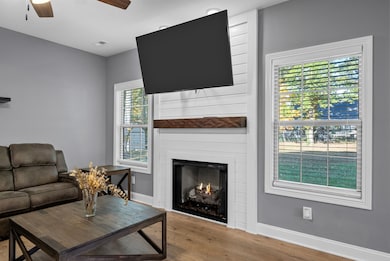 Fireplace with shiplap surround and wooden mantle
