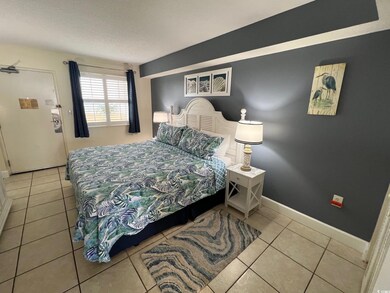 Bedroom featuring tile patterned floors and a text