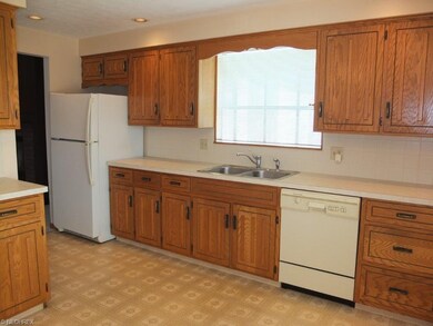 Kitchen has tile backsplash and pantry.