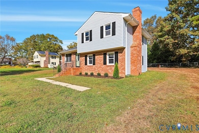 View of front of home with a chimney and brick siding