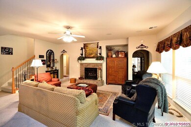 A brick, gas log fireplace with wood mantle is a f