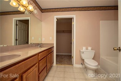 Master Bath has double vanity with walk in closet.