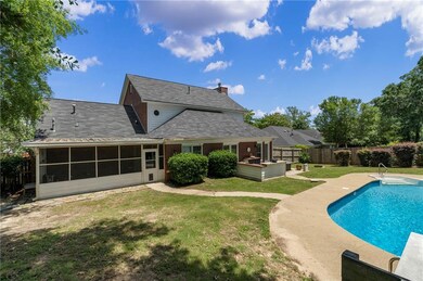 View of pool featuring a sunroom and a patio