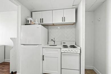 Kitchen with tasteful backsplash, a paneled ceilin
