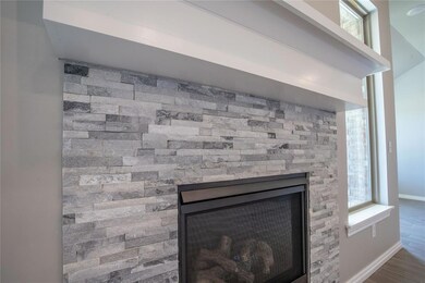 Details with hardwood / wood-style floors and a fireplace