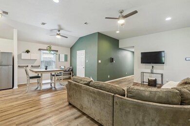 Living room with lofted ceiling, light wood-style 