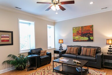 Spacious living room is light filled with 3 large 