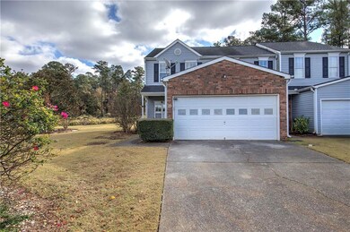 Traditional-style home with a front yard and concrete driveway