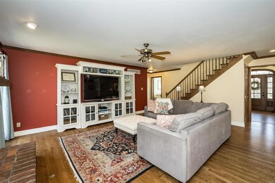 Looking from the picture window into the large 19 x 16 Family Room with gas logs and hardwood floors.