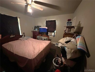 Bedroom with cooling unit and ceiling fan