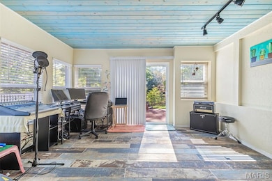 Bright flex room in lower level makes a great office space.