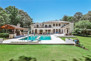 Fabulous back yard with pool, fully equipped outdoor kitchen with eating area, entertaining space and double fireplace.