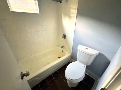 Full bathroom featuring toilet and shower / washtub combination