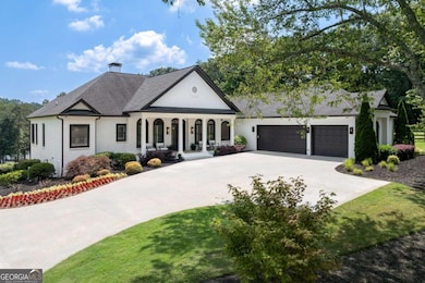 View of front of house featuring covered porch, driveway, an attached garage, a chimney, and roof with shingles