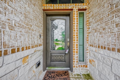 This inviting entryway features a charming brick f