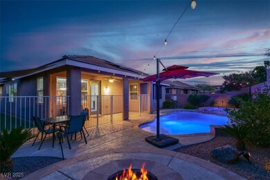 Pool at dusk featuring ceiling fan, a fire pit, a