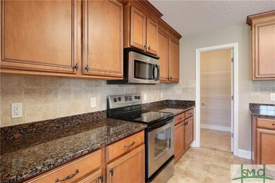 Granite countertops, beautiful wood cabinetry and 
