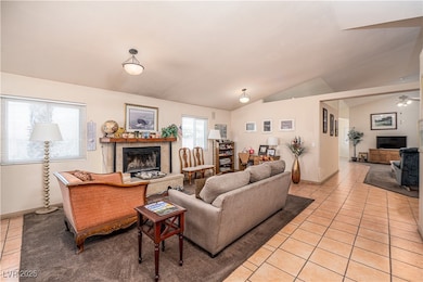 Living room with a tile fireplace, light tile patt