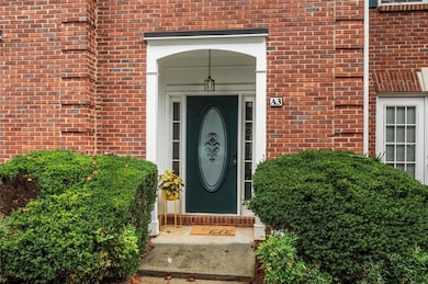 View of exterior entry with brick siding