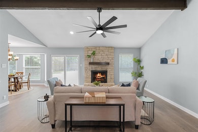 Living area with vaulted ceiling, ceiling fan, wo