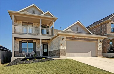 View of front of home featuring a garage, stone s