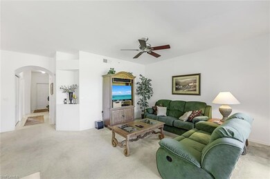 Living room featuring ceiling fan and carpet floor