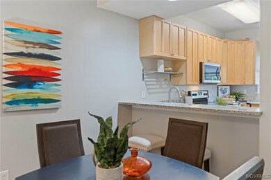 Kitchen with light stone counters, electric range,