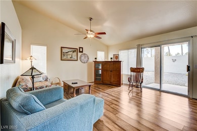 Living area featuring lofted ceiling, light wood-t