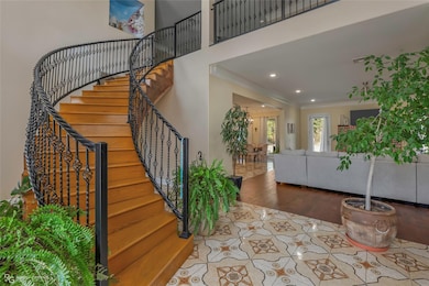 Entryway featuring stairway, wood finished floors,