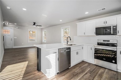 Kitchen with kitchen peninsula, appliances with st