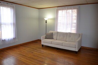 Living room features hardwood floors and a coat/st