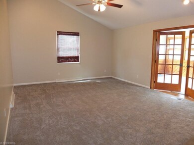 Family room with vaulted ceiling and fireplace.
