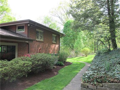 Exterior Front. Pathway along back of home to leve