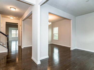 Living room (foreground), foyer, dining room