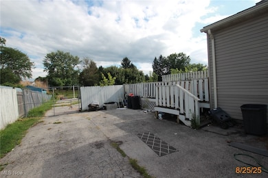 Fenced backyard with a patio and a gate