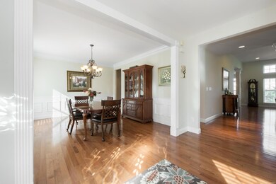 The dining room features detailed millwork, including wainscoting, crown molding, tall baseboards and door trim!