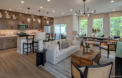 Living area with light wood-type flooring, recessed lighting, and a chandelier