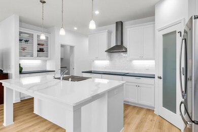 Built-in Buffet, oversized island, frosted glass pantry.