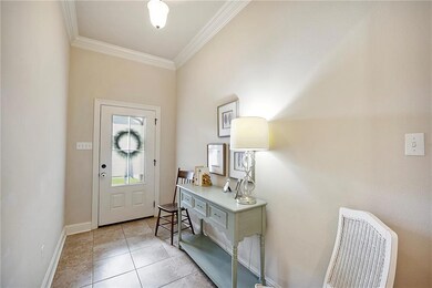 The foyer has abundant natural light and a coat closet.