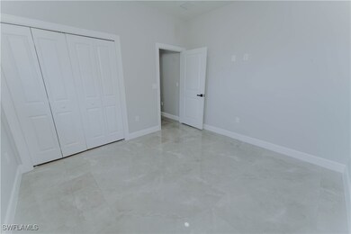 Unfurnished bedroom with a closet, baseboards, and