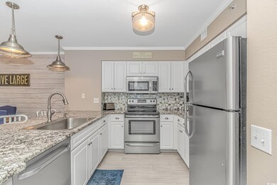 Kitchen featuring pendant lighting, sink, white ca
