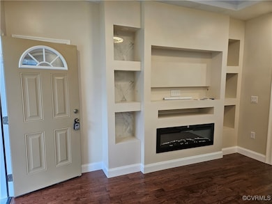 Entryway featuring dark wood-style floors, baseboa