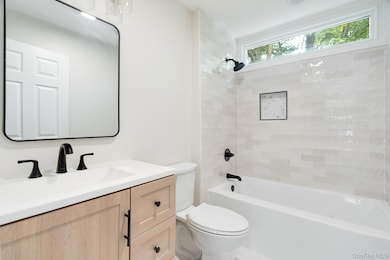Bathroom featuring bathing tub / shower combination and vanity